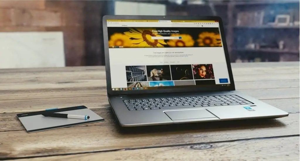 Will AI Replace Graphic Designers: A Complete Guide gray laptop on wooden table
