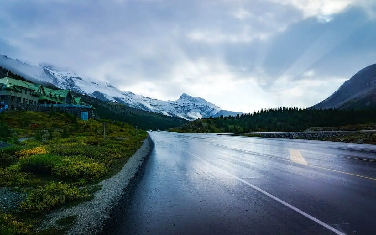 How Far Is Lake Louise from Banff? The Banff highway with mountains in the background.