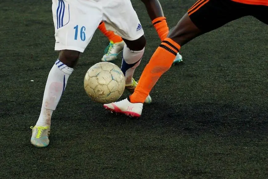 What Does FT Mean in Soccer? people playing soccer and kicking the ball.
