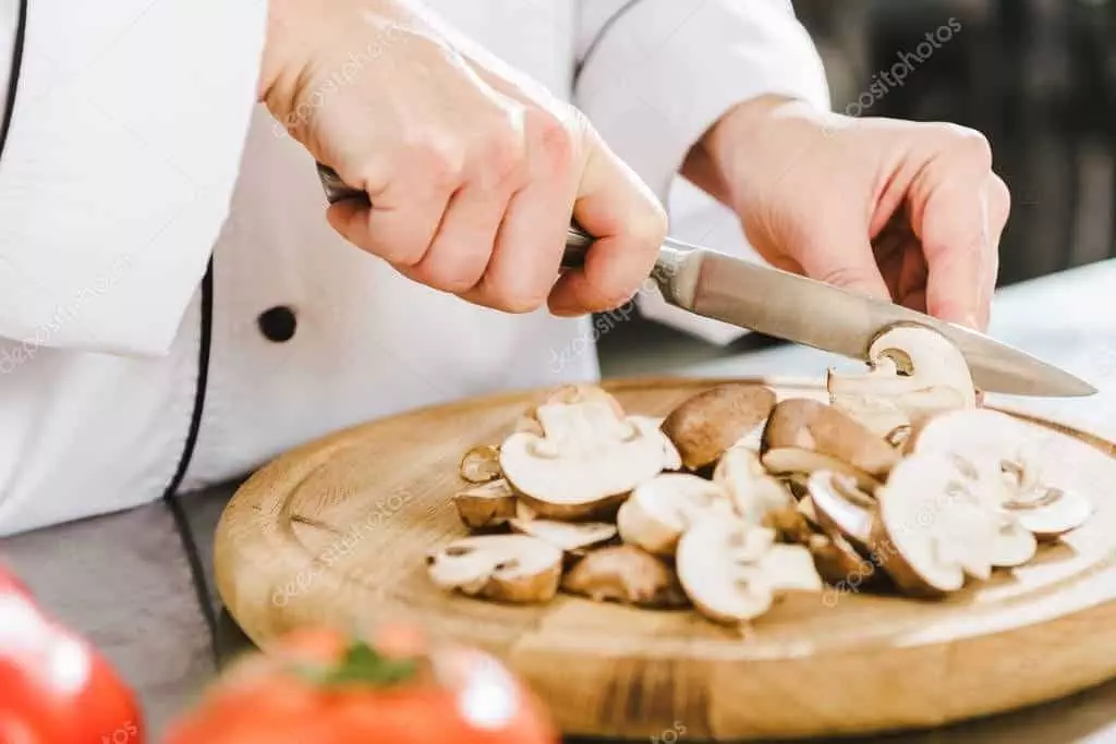 Chef slicing mushrooms 