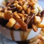A bowl of poutine - Canadian snacks.