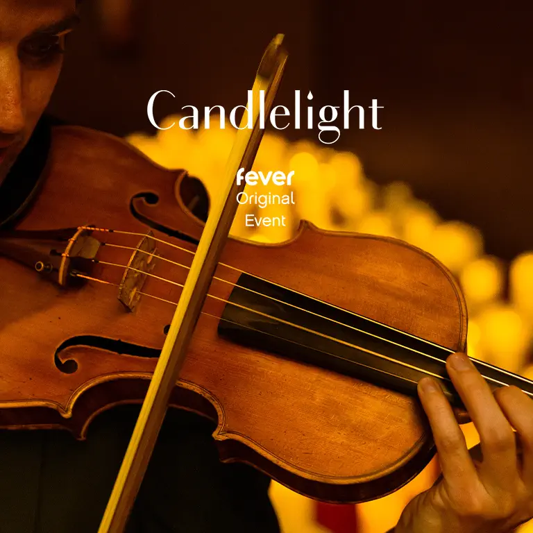 A person playing the violin with dim golden lights. A cover photo from Fever of Candlelight: Film Scores and Hollywood Epics.
