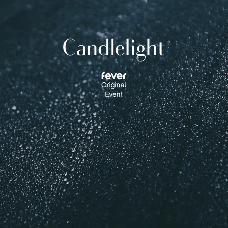 A close-up of water sprinkles on black background, an image taken at an angle. There is an event of Candlelight