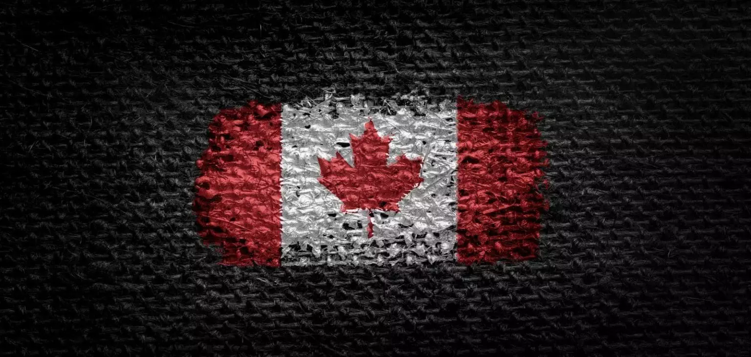 35412456 national flag of the canada on dark fabric