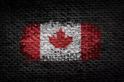 35412456 national flag of the canada on dark fabric scaled