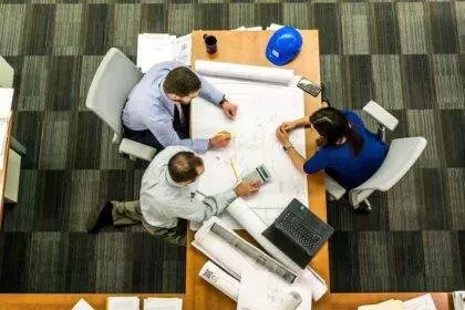 A group of professionals working together on a table.