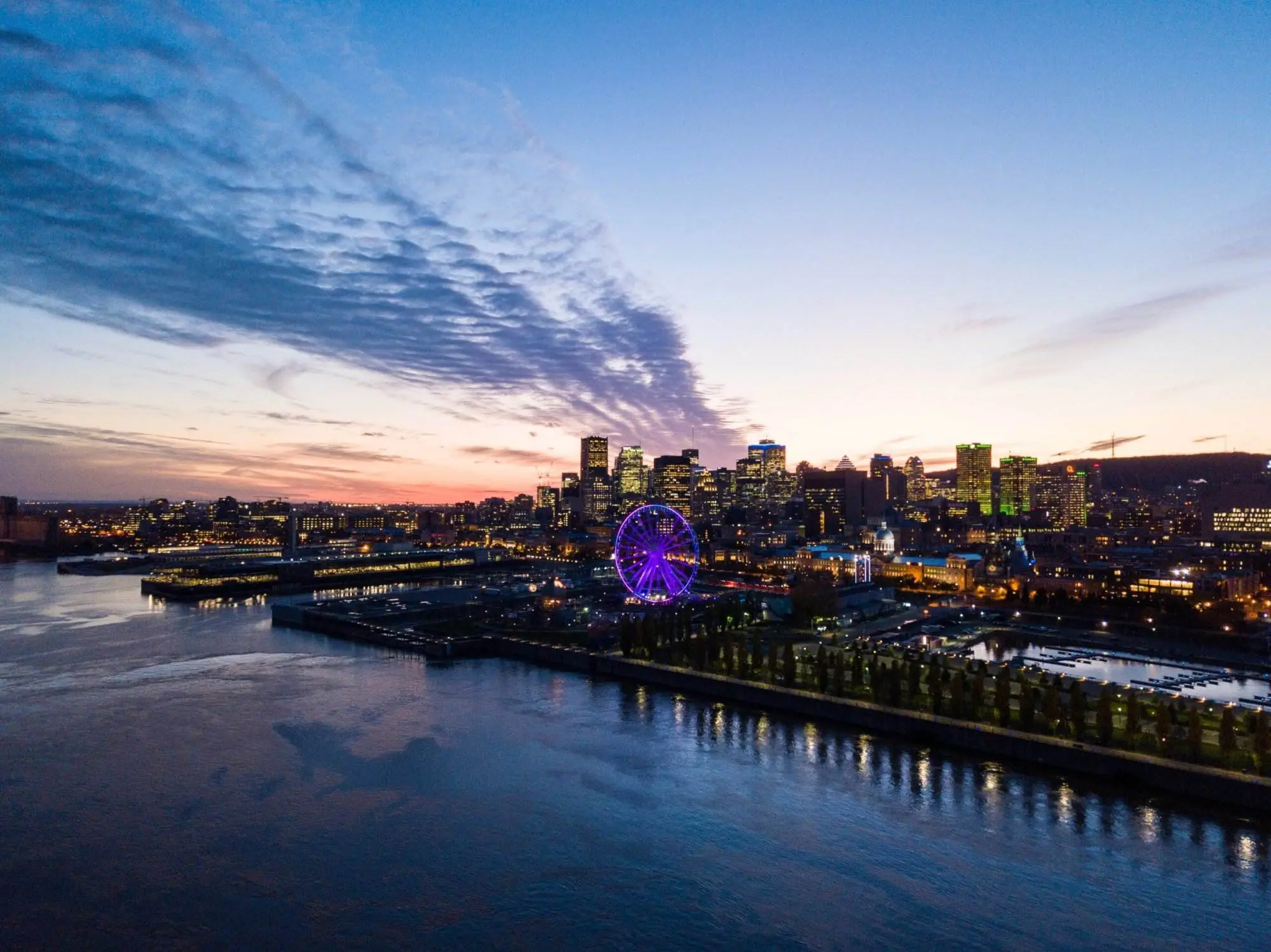 What Is Canada Known For: The 10 Compelling Facts A scenic view of Montreal City in Canada. A sea view and many houses and tall buildings are visible across the sea.