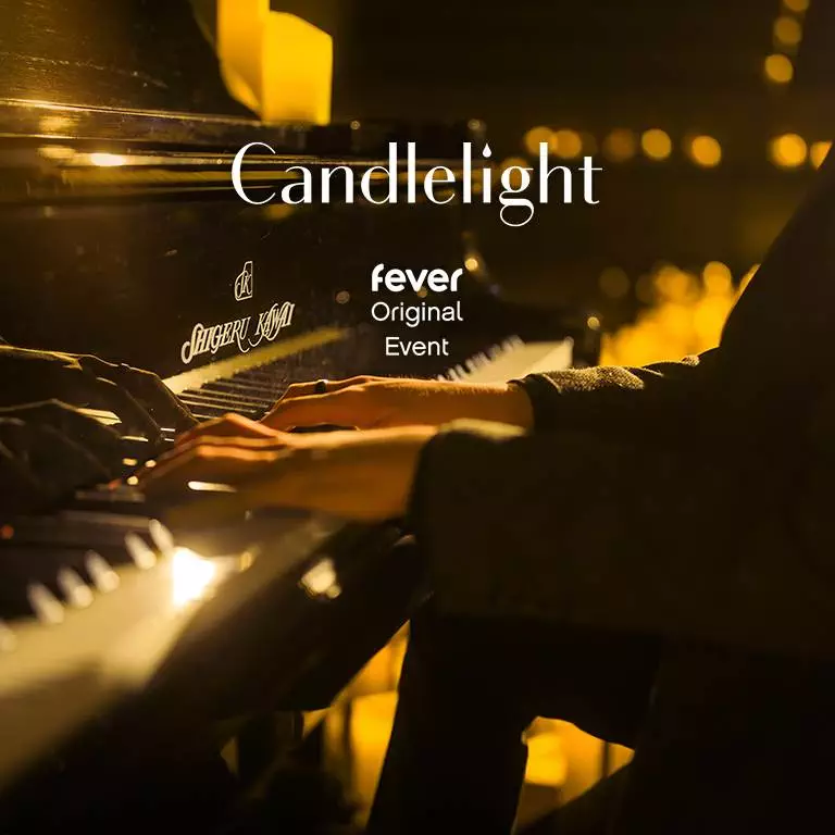 A close-up of a piano played by a person during a performance for Candlelight