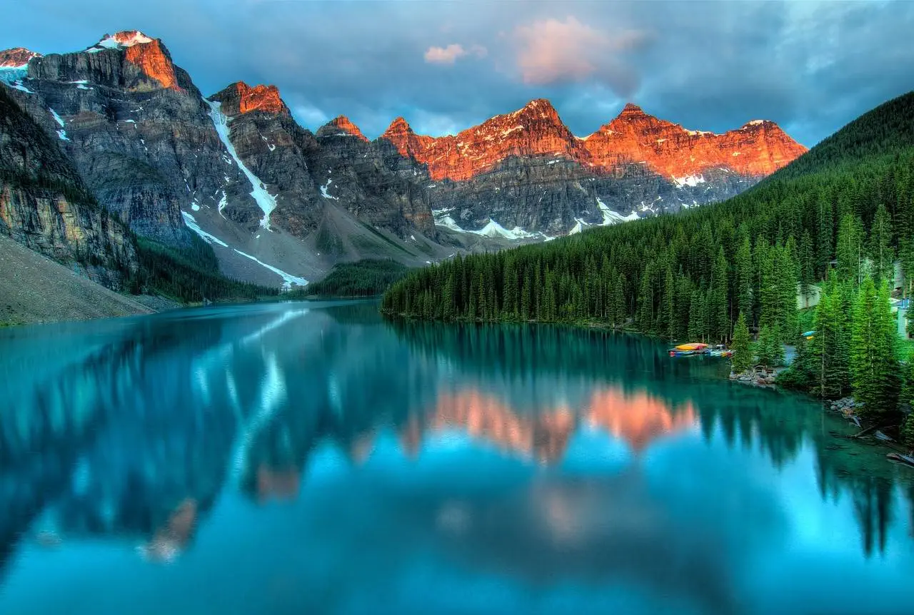 The 12 Best Mountain Ranges in Canada A view from one of the best mountain ranges in Canada, named Canadian Rockies. A scenic view of huge mountain ranges with a sea view at the bottom.