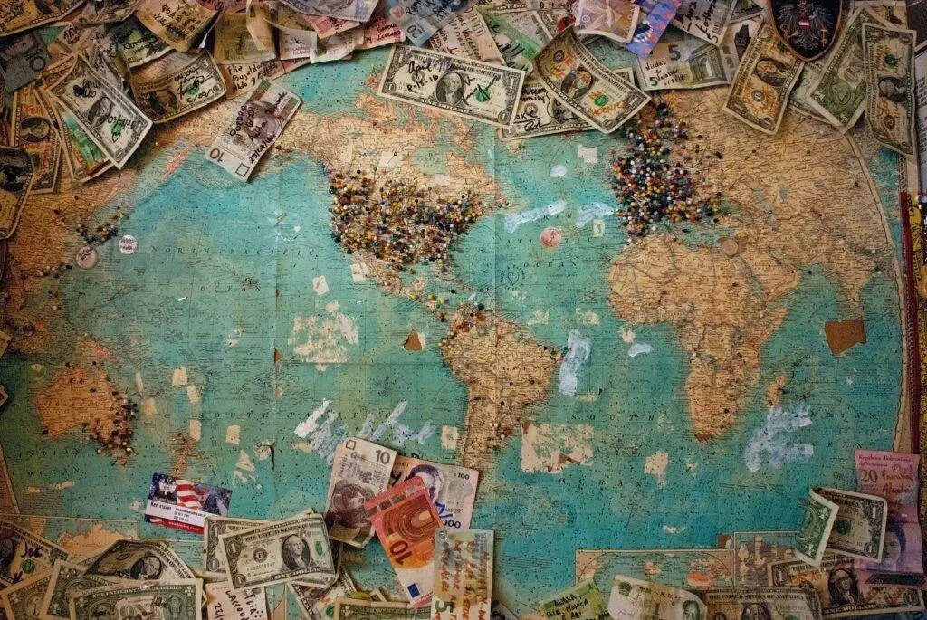 What are the Top Bank-Free Money Transfer Methods? A view of money in all over the world map.