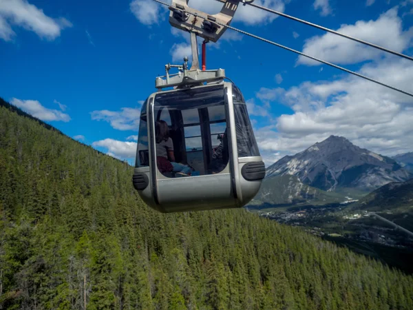 Banff Sulphur Mountain Gondola on the way up the mountain with Mount Rundle in the background.