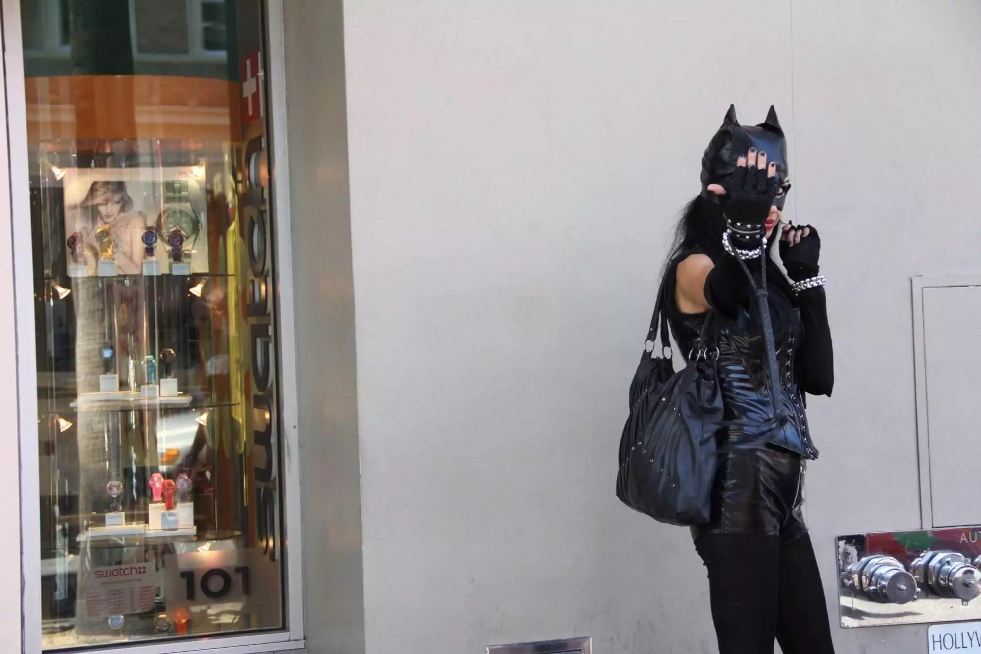 A woman wearing an all-black cat costume and showing her nails for Toronto