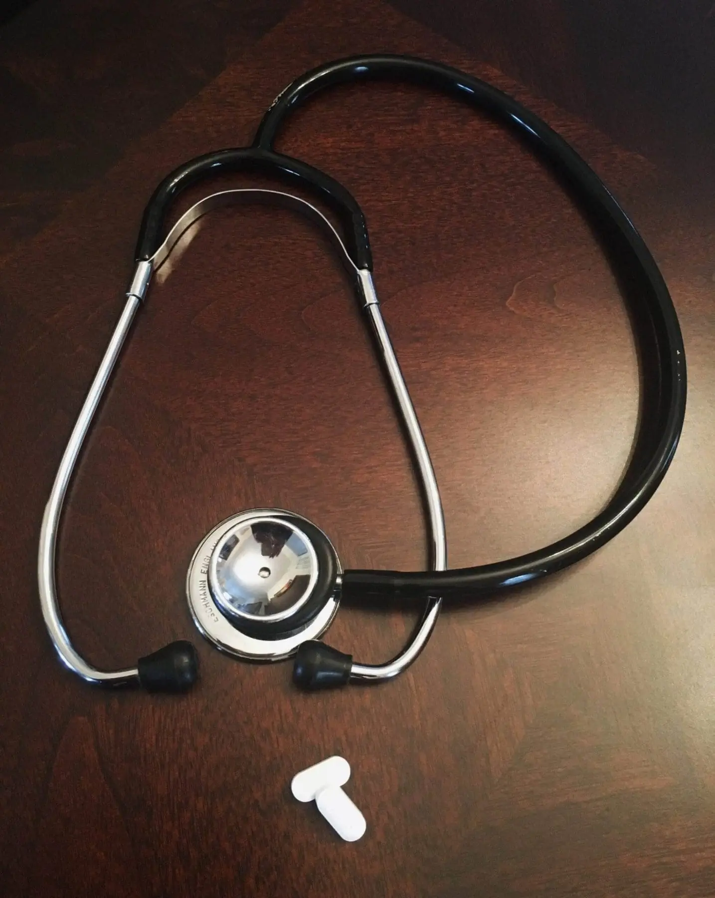 How to Claim for Health Insurance in Canada? A black stethoscope lying on a wooden table.