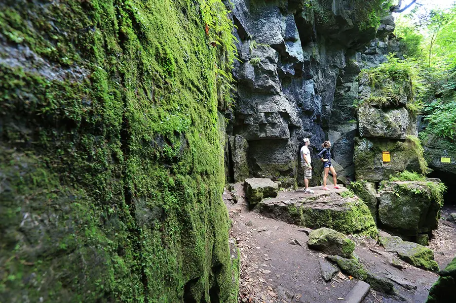 Everything You Can Do at the Blue Mountains Scenic Caves? Two people standing in the rocky path in the Scenic Caves