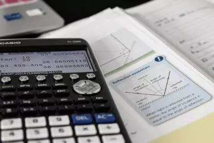 A view of mathematics study with a calculator on a maths book.