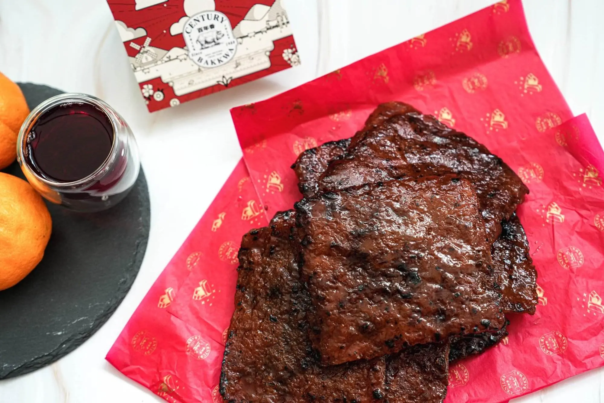A Complete Guide on What to Buy in Singapore Two pieces of Bak kwa with sauce.