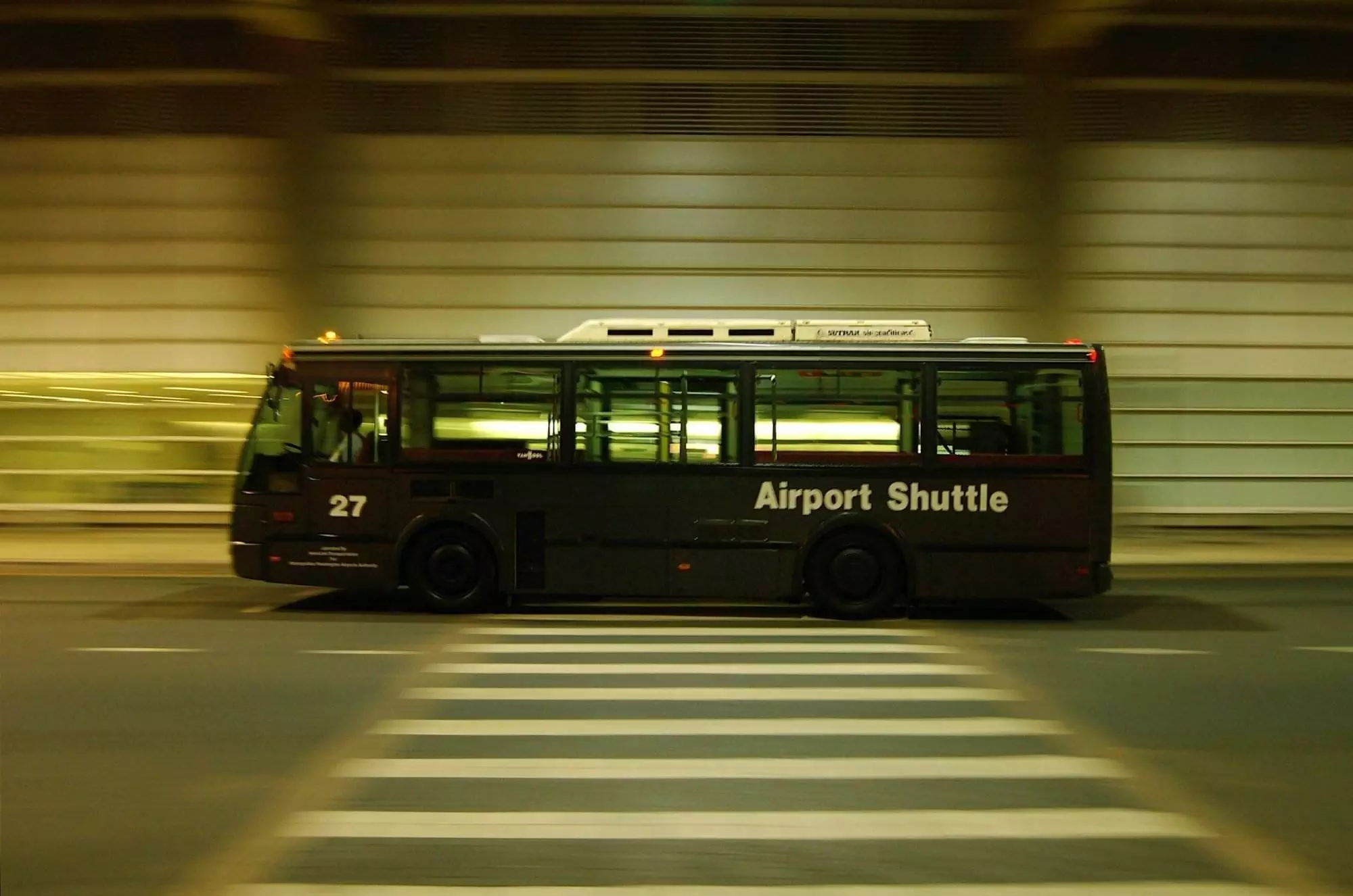 An airport bus running on the road.