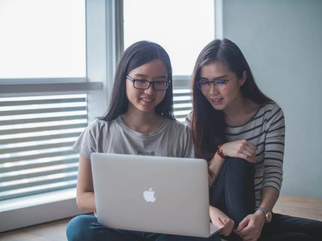 How Has Computer Science Impacted Art, with Some Examples Two ladies work on a laptop.
