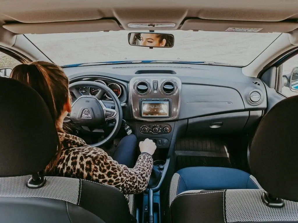 What to Do after Buying a Used Car? woman driving a her car on the road