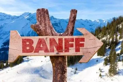 A sign board of Banff on a tree twig.