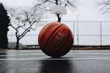 A basketball on a court ground.