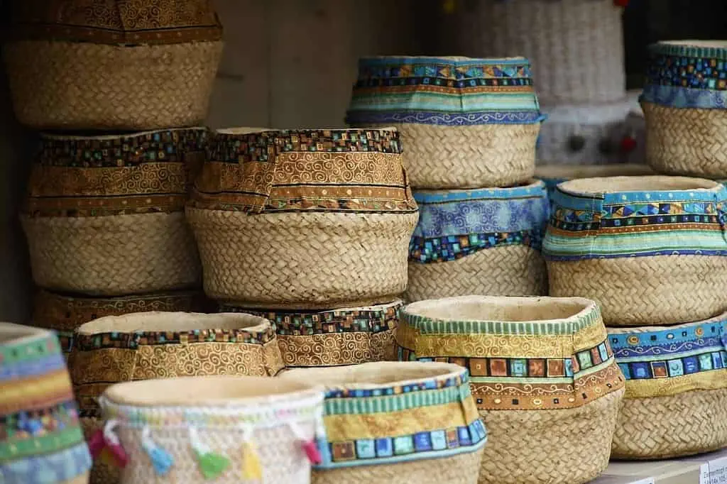 13 Amazing Things to Buy in Morocco Jute baskets with designs stacked in a shop to buy.
